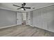 Bright bedroom with hardwood floors, a ceiling fan, and an open doorway to another room at 6306 Aberdeen Ave, New Port Richey, FL 34653
