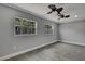 Bedroom featuring tile flooring and windows offering natural light at 6306 Aberdeen Ave, New Port Richey, FL 34653