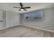 This bedroom features a spacious closet with a door, a window, and modern ceiling fan at 6306 Aberdeen Ave, New Port Richey, FL 34653