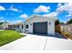 Charming single-story home featuring a gray exterior, attached garage, and well-maintained lawn at 6306 Aberdeen Ave, New Port Richey, FL 34653