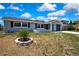 Charming single-story home features a gray painted exterior, dark shutters, and a well-manicured front yard at 6306 Aberdeen Ave, New Port Richey, FL 34653