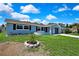 A charming home with a lush front yard and well-manicured landscaping welcomes you at 6306 Aberdeen Ave, New Port Richey, FL 34653