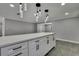 Open kitchen with an island featuring pendant lights, modern cabinets, and stylish flooring at 6306 Aberdeen Ave, New Port Richey, FL 34653