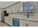 Modern kitchen with white cabinets, quartz countertops, stainless steel appliances, and a bright window at 6306 Aberdeen Ave, New Port Richey, FL 34653