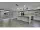 Open-concept kitchen with an island seamlessly flowing into the dining area, perfect for entertaining at 6306 Aberdeen Ave, New Port Richey, FL 34653