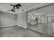 Living room leading to a kitchen with a large island and modern pendant lighting at 6306 Aberdeen Ave, New Port Richey, FL 34653