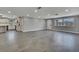 Large living room featuring gray flooring, recessed lighting, and an open layout leading to the kitchen area at 6306 Aberdeen Ave, New Port Richey, FL 34653
