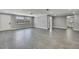 Spacious living room with sleek gray tile flooring, recessed lighting, and neutral gray wall color throughout at 6306 Aberdeen Ave, New Port Richey, FL 34653