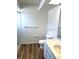 Bright bathroom featuring a granite sink, a shower stall, a toilet, a mirror and laminate flooring at 6354 Freeport Dr, Spring Hill, FL 34608