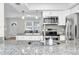 Close up of kitchen showcasing the sink, faucet, and granite countertop details, with the living area in background at 755 Green Valley Rd, Palm Harbor, FL 34683
