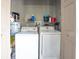 Functional laundry room equipped with washer, dryer, and shelving for storage at 755 Green Valley Rd, Palm Harbor, FL 34683