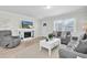 Comfortable living room with a decorative fireplace, natural light, and neutral toned furniture at 755 Green Valley Rd, Palm Harbor, FL 34683