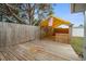Wooden deck in backyard with bar and overhead awning, partially enclosed by fencing at 7735 Farmlawn Dr, Port Richey, FL 34668