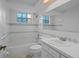 This bathroom features a bathtub, white tiled walls, and a built-in vanity at 7735 Farmlawn Dr, Port Richey, FL 34668