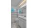 Bathroom featuring a bathtub, white tiling, built-in vanity, and decorative window at 7735 Farmlawn Dr, Port Richey, FL 34668