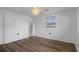 Bright bedroom with wood-look floors, a ceiling fan, and an en-suite bathroom at 7735 Farmlawn Dr, Port Richey, FL 34668