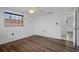 Bedroom with new wood-look floors and large windows, offering plenty of sunlight at 7735 Farmlawn Dr, Port Richey, FL 34668