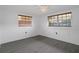 Inviting bedroom with durable floors, bright windows, and a modern ceiling fan at 7735 Farmlawn Dr, Port Richey, FL 34668