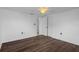 This room features wood-look flooring, neutral paint, and a ceiling fan with overhead lighting at 7735 Farmlawn Dr, Port Richey, FL 34668