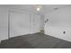 Bright bedroom with gray wood-look flooring, white trim, a ceiling fan, and a closet at 7735 Farmlawn Dr, Port Richey, FL 34668