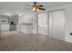Open kitchen and dining area with tile flooring, ceiling fans, and stainless steel appliances at 7735 Farmlawn Dr, Port Richey, FL 34668