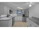 This kitchen features stainless steel appliances, granite countertops, and tile flooring at 7735 Farmlawn Dr, Port Richey, FL 34668