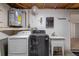 Functional laundry room with washer, dryer, utility sink, and water heater at 7735 Farmlawn Dr, Port Richey, FL 34668