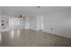 View of the spacious living room showcasing tile floors, ceiling fan, and natural light at 7735 Farmlawn Dr, Port Richey, FL 34668