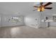 Bright living room featuring tile flooring and an adjacent kitchen area at 7735 Farmlawn Dr, Port Richey, FL 34668