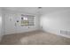 Bright living room showcasing a window, tile floors, white door, and a ceiling fan at 7735 Farmlawn Dr, Port Richey, FL 34668