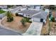 Aerial view of a well-maintained property with landscaping, driveway, and a tidy front yard at 7736 Gaston Dr, Port Richey, FL 34668