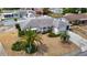 Aerial view of a well-maintained property with landscaping, driveway, and a tidy front yard at 7736 Gaston Dr, Port Richey, FL 34668