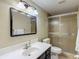Bathroom featuring a vanity, mirror, and glass-enclosed shower stall at 7736 Gaston Dr, Port Richey, FL 34668