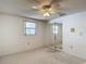 Neutral bedroom with a ceiling fan and mirrored closet doors at 7736 Gaston Dr, Port Richey, FL 34668