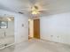 Bedroom featuring a ceiling fan, carpet, and closet with mirrored doors at 7736 Gaston Dr, Port Richey, FL 34668