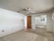 Neutral bedroom with a ceiling fan, carpeted floor, and mirrored closet at 7736 Gaston Dr, Port Richey, FL 34668