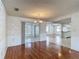 This dining room has hardwood floors and sliding glass doors to a sunroom at 7736 Gaston Dr, Port Richey, FL 34668