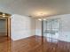 A dining room with hardwood floors, wainscoting and sliding glass doors to a sunroom at 7736 Gaston Dr, Port Richey, FL 34668