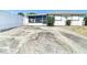 Exterior of a charming home with a screened in patio and ample driveway space for multiple cars at 7736 Gaston Dr, Port Richey, FL 34668