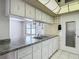 A kitchen with white cabinets, stainless steel appliances, and a tile backsplash at 7736 Gaston Dr, Port Richey, FL 34668