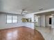 Open-concept living room with hardwood floors adjacent to the kitchen and tile entryway at 7736 Gaston Dr, Port Richey, FL 34668