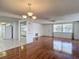 Open-concept living area with hardwood floors and views into the kitchen at 7736 Gaston Dr, Port Richey, FL 34668