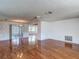 Spacious living room with hardwood floors and a ceiling fan at 7736 Gaston Dr, Port Richey, FL 34668