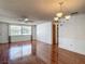Open-concept living room with hardwood floors, dining area and natural light at 7736 Gaston Dr, Port Richey, FL 34668