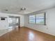 Cozy living room with sliding doors and a large window offering plenty of natural light at 7736 Gaston Dr, Port Richey, FL 34668