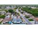 A residential neighborhood with tree-lined streets, single-Gathering homes, and a bank in the distance at 7736 Gaston Dr, Port Richey, FL 34668
