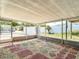 Outdoor patio with pebble and tile flooring, surrounded by screened windows at 7736 Gaston Dr, Port Richey, FL 34668