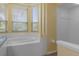 A bathroom with a white tub and a separate shower near a bay window at 8382 Christopher Ln, Weeki Wachee, FL 34613