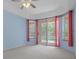 Bedroom with vaulted ceiling, ceiling fan, and sliding doors to the pool at 8382 Christopher Ln, Weeki Wachee, FL 34613