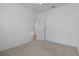 Bright bedroom features neutral carpet and walls with door to a sunny lanai at 8382 Christopher Ln, Weeki Wachee, FL 34613